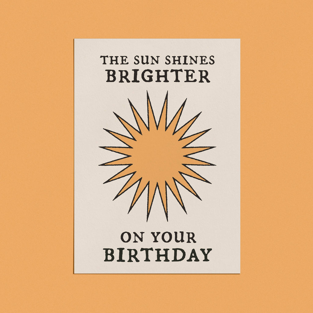 Minimalist birthday card with a sunburst design and bold typography that reads "The Sun Shines Brighter on Your Birthday."