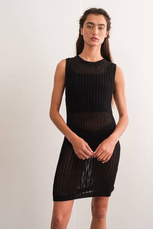 Woman wearing a sleeveless black crochet mini dress.