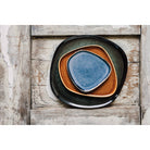 Tumble Stone plate with a smooth, polished surface in deep blue hues, inspired by the natural beauty of tumbled stones.