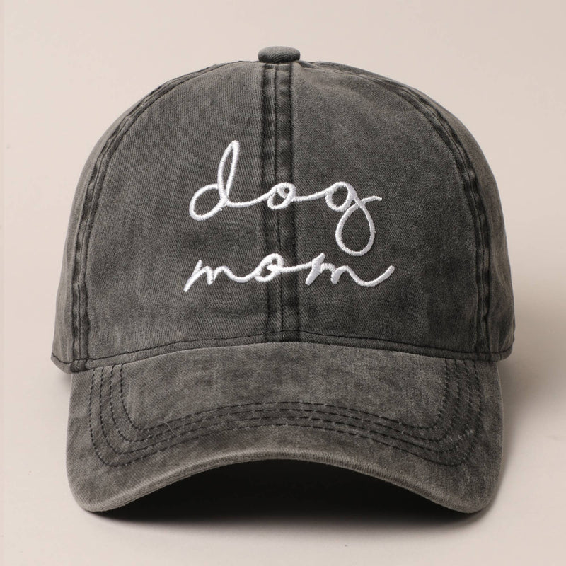 Gray cap with 'dog mom' embroidery on a beige background