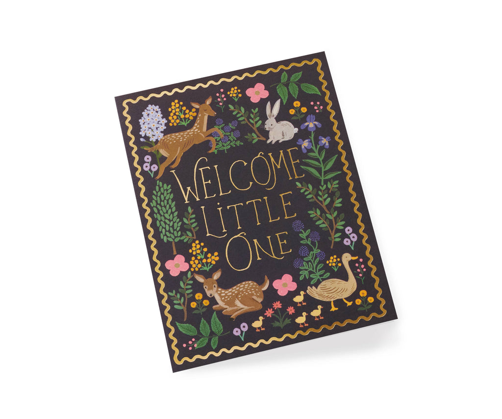 "Welcome Little One" baby greeting card with gold lettering, woodland animals, and floral details, paired with a pastel envelope.