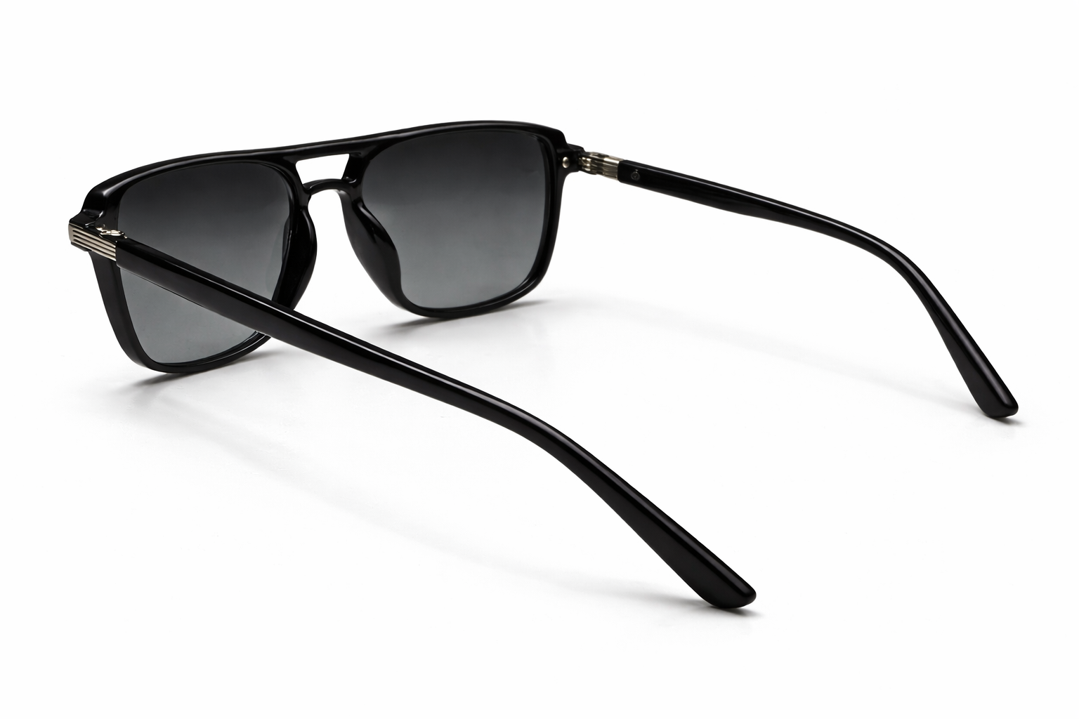 Black sunglasses with dark lenses on a white background