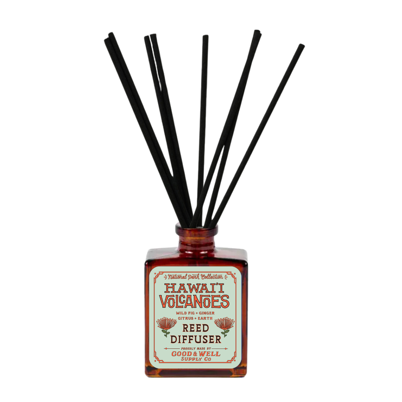 Hawai‘i Volcanoes reed diffuser with amber bottle and black reeds by Good & Well Supply Co., featuring wild fig, ginger, and citrus.