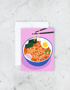 Greeting card with a bowl of ramen illustration on a pink background