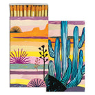 Matchbox with a colorful desert landscape illustration, featuring cacti and sunset-inspired tones.