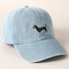 Light blue denim cap with embroidered dachshund on a beige background