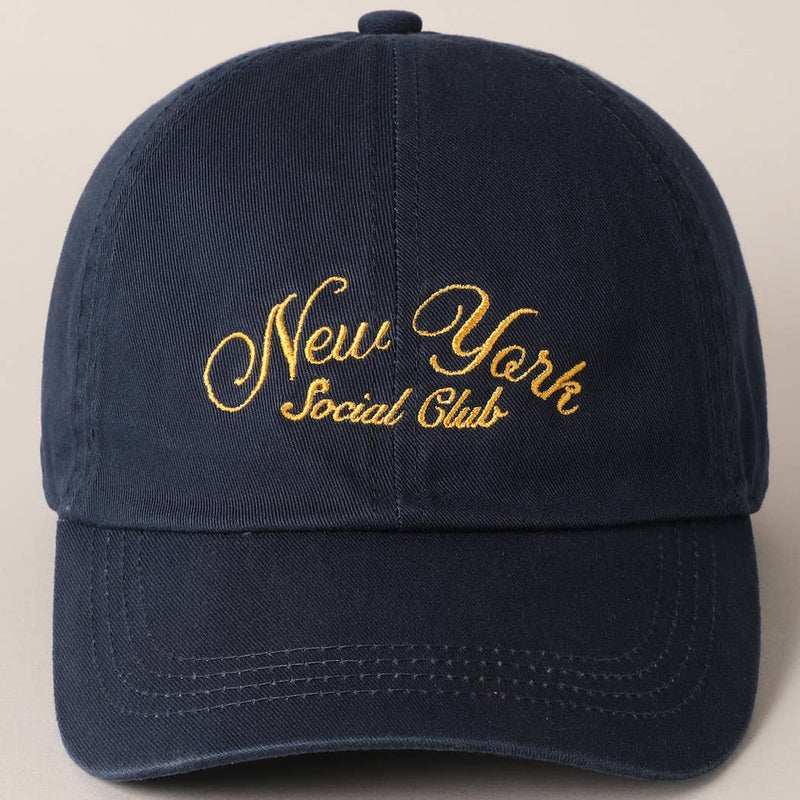 Beige and navy New York Social Club embroidered baseball caps with curved brims.