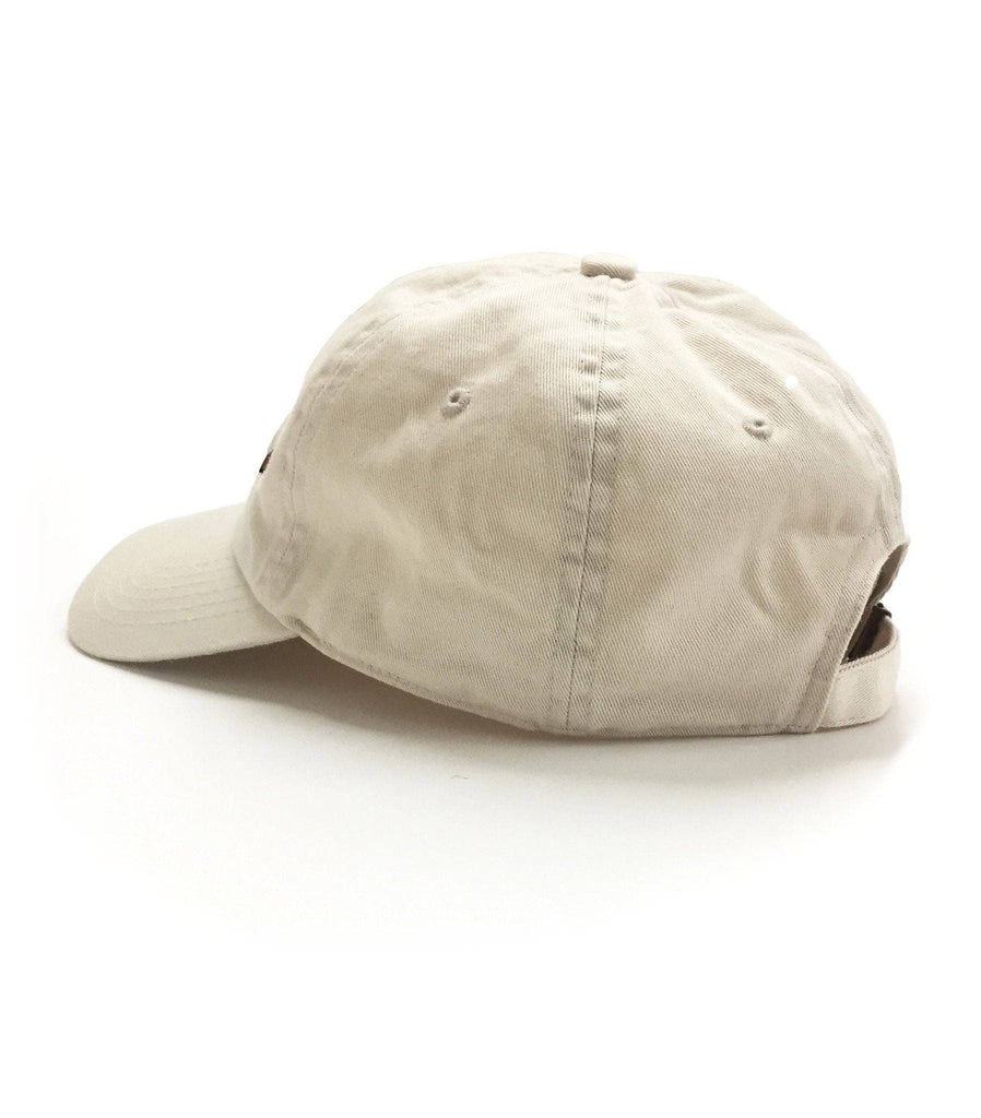 Beige baseball cap with embroidered whiskey glass and cigar design on the front.