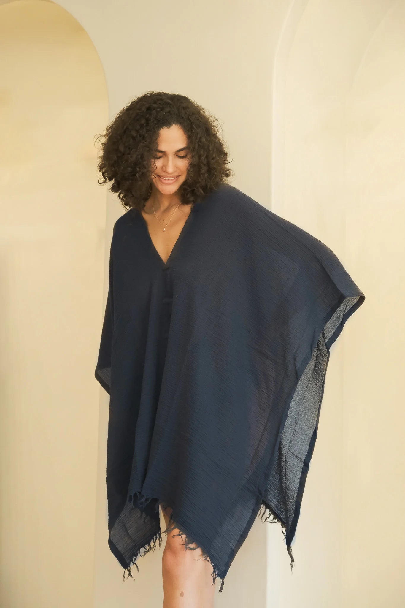 A woman gracefully wearing the Ava Kimono, showcasing its flowing silhouette, delicate patterns, and high-quality fabric.
