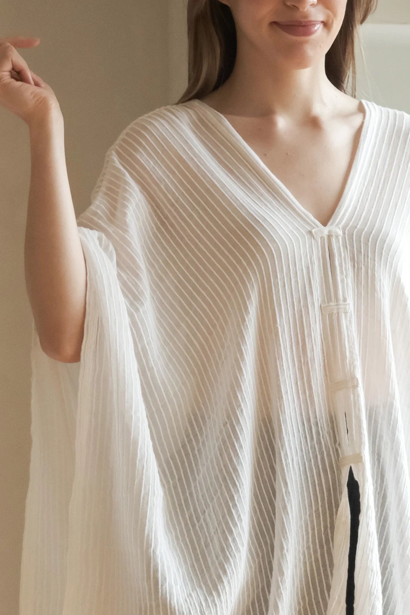 A woman gracefully wearing the Ava Kimono, showcasing its flowing silhouette, delicate patterns, and high-quality fabric.
