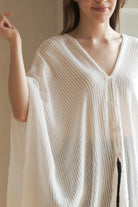 A woman gracefully wearing the Ava Kimono, showcasing its flowing silhouette, delicate patterns, and high-quality fabric.