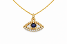 Gold necklace with an eye-shaped pendant featuring a blue gemstone on a white background