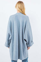 Olivia Cardigan showcasing its open-face design, lightweight knit fabric, and ribbed detailing, ideal for effortless and stylish layering.