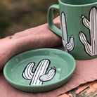 A vibrant and unique cactus-shaped coaster on a table.