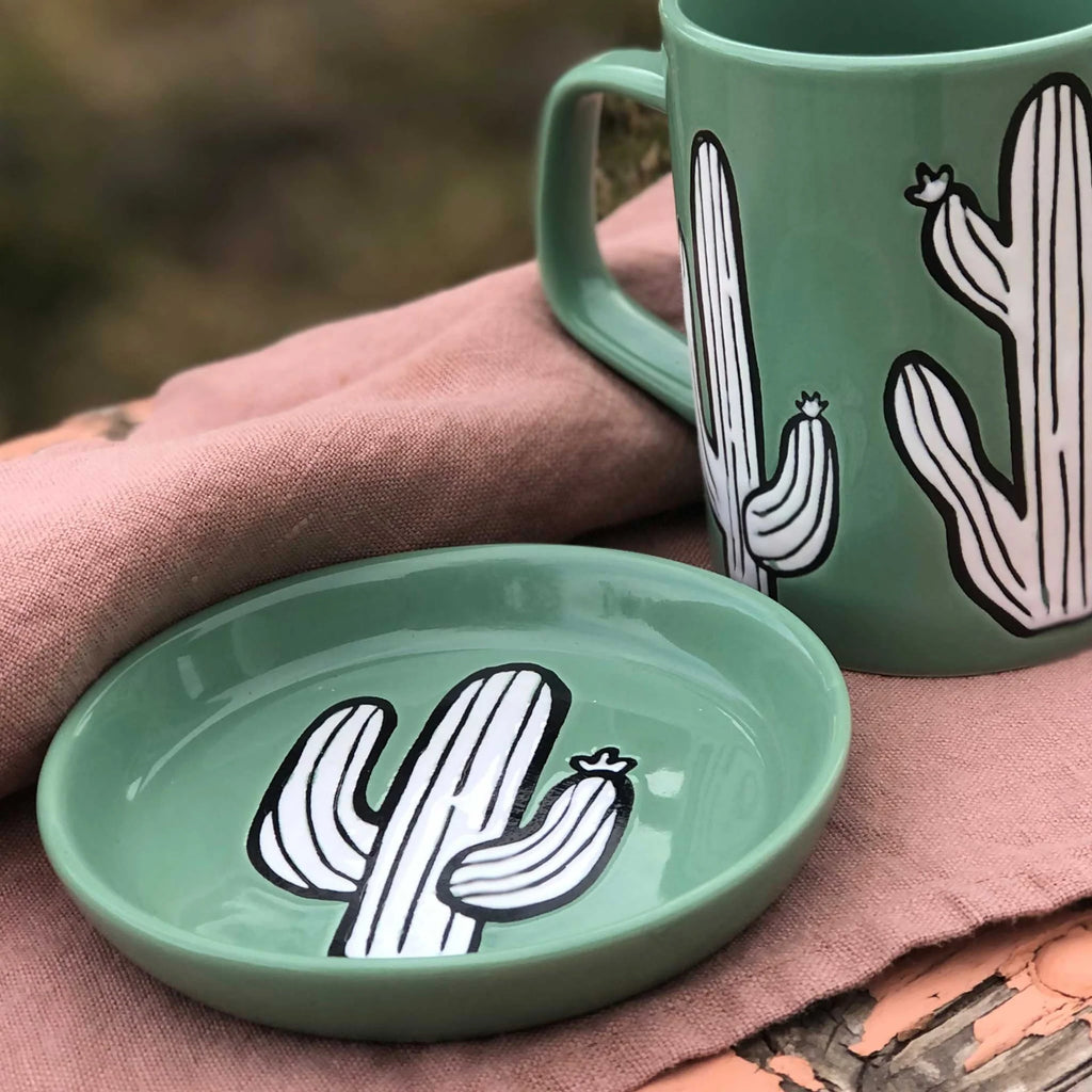 A vibrant and unique cactus-shaped coaster on a table.