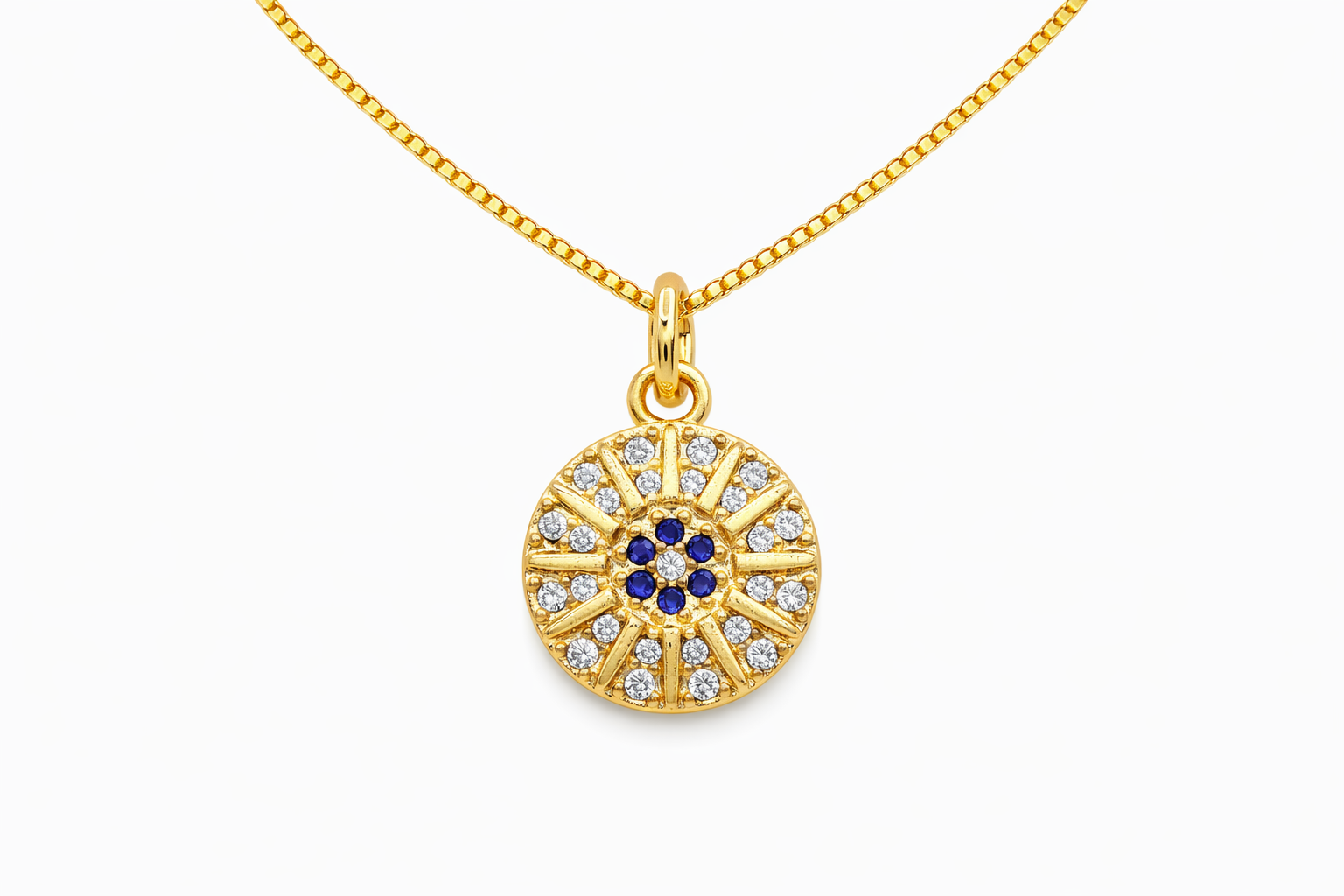 Gold necklace with a circular pendant featuring blue and clear stones on a white background
