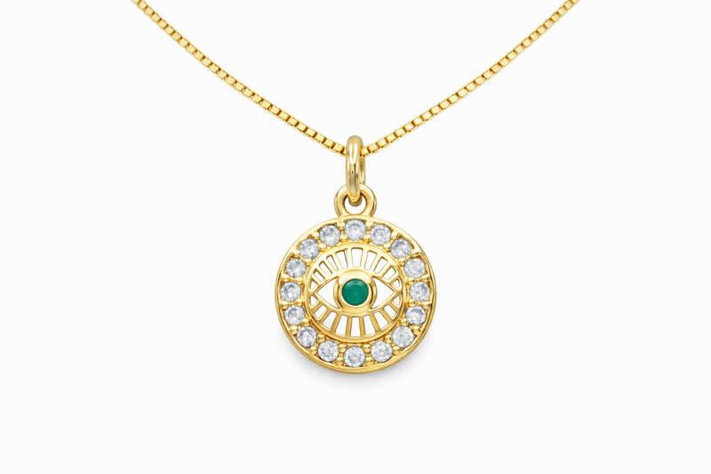 Gold necklace with an eye-shaped pendant on a white background