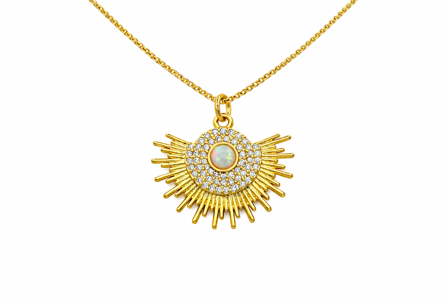 Gold necklace with a sunburst pendant featuring a central gemstone on a white background