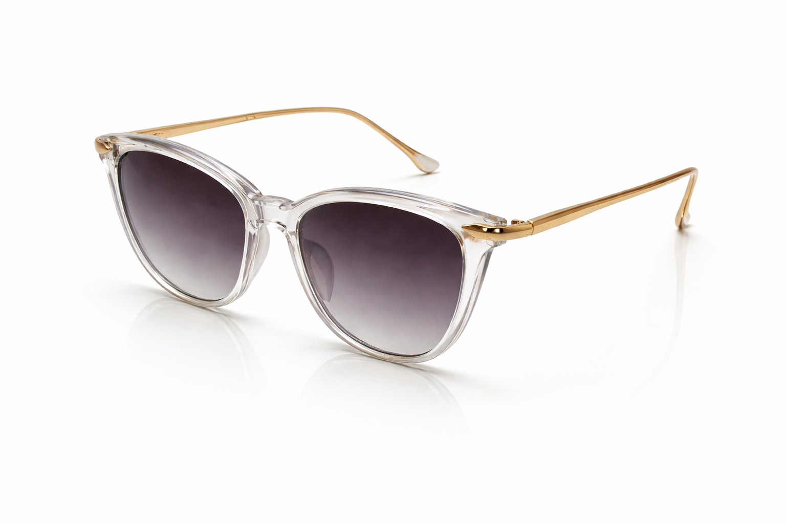 Sunglasses with gold frame and clear lens on a white background