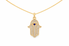 Gold Hamsa hand pendant necklace with a blue stone on a white background
