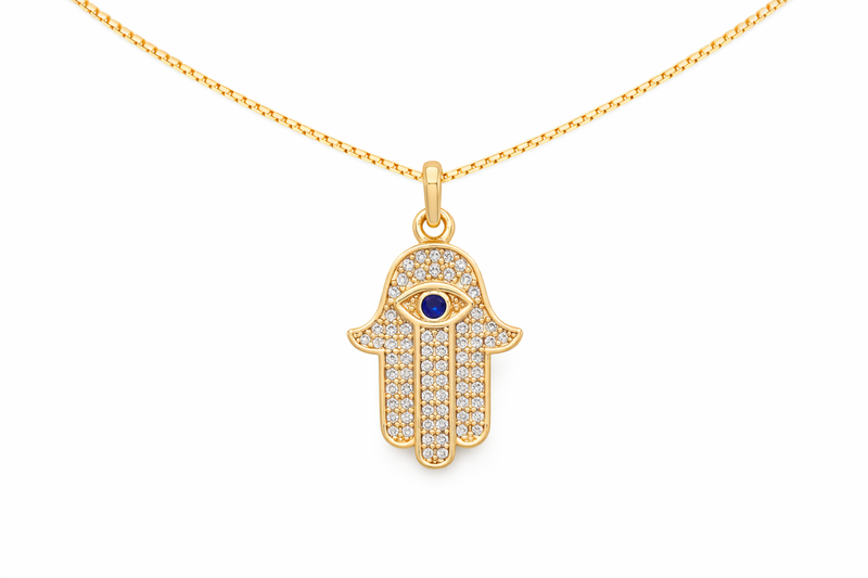 Gold Hamsa hand pendant necklace with a blue stone on a white background