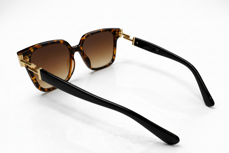 Sunglasses with tortoiseshell frame and brown lenses on a white background