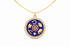 Gold necklace with a blue pendant featuring various symbols on a white background