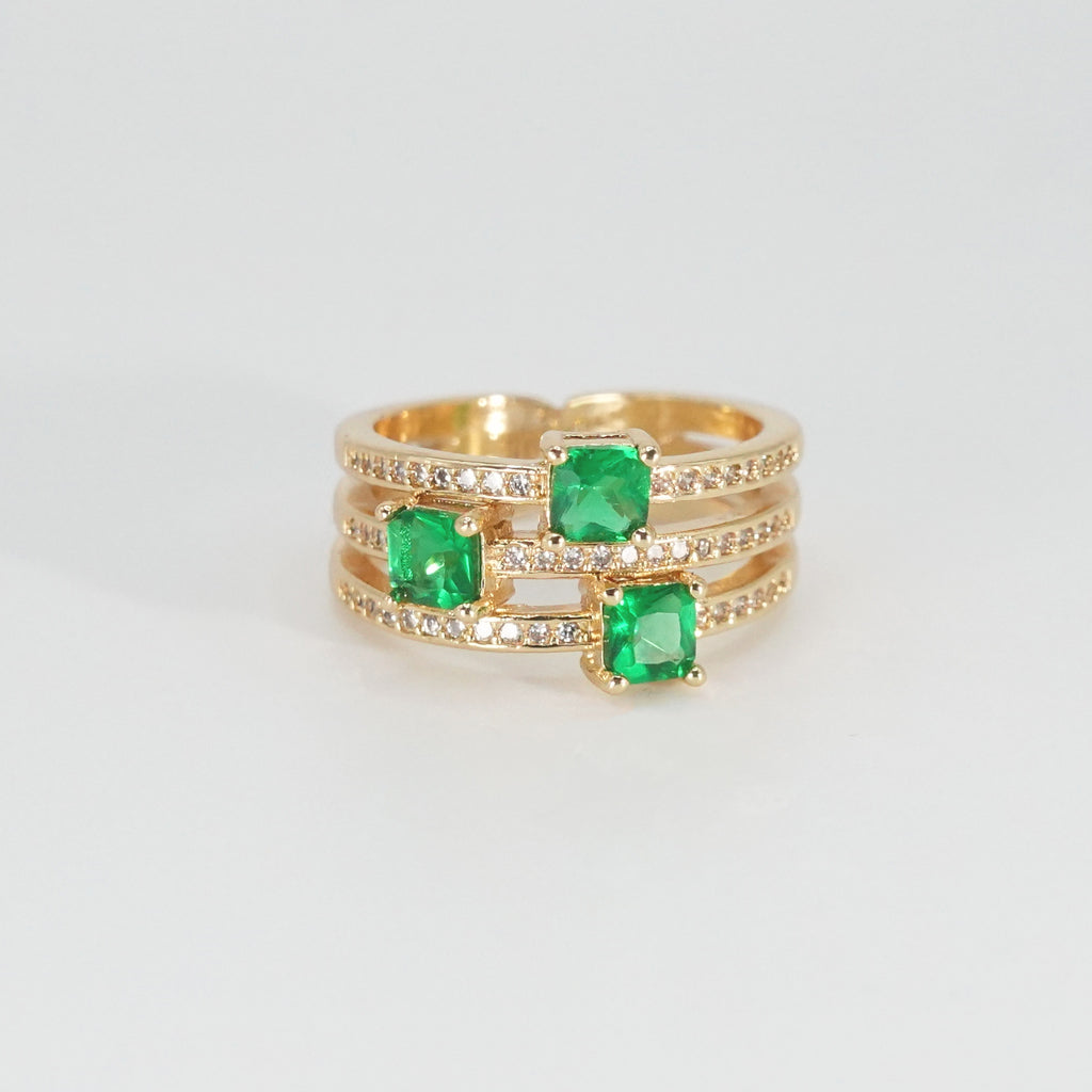Forest Ring: Wide design adorned with shimmering green stones, epitome of natural beauty.
