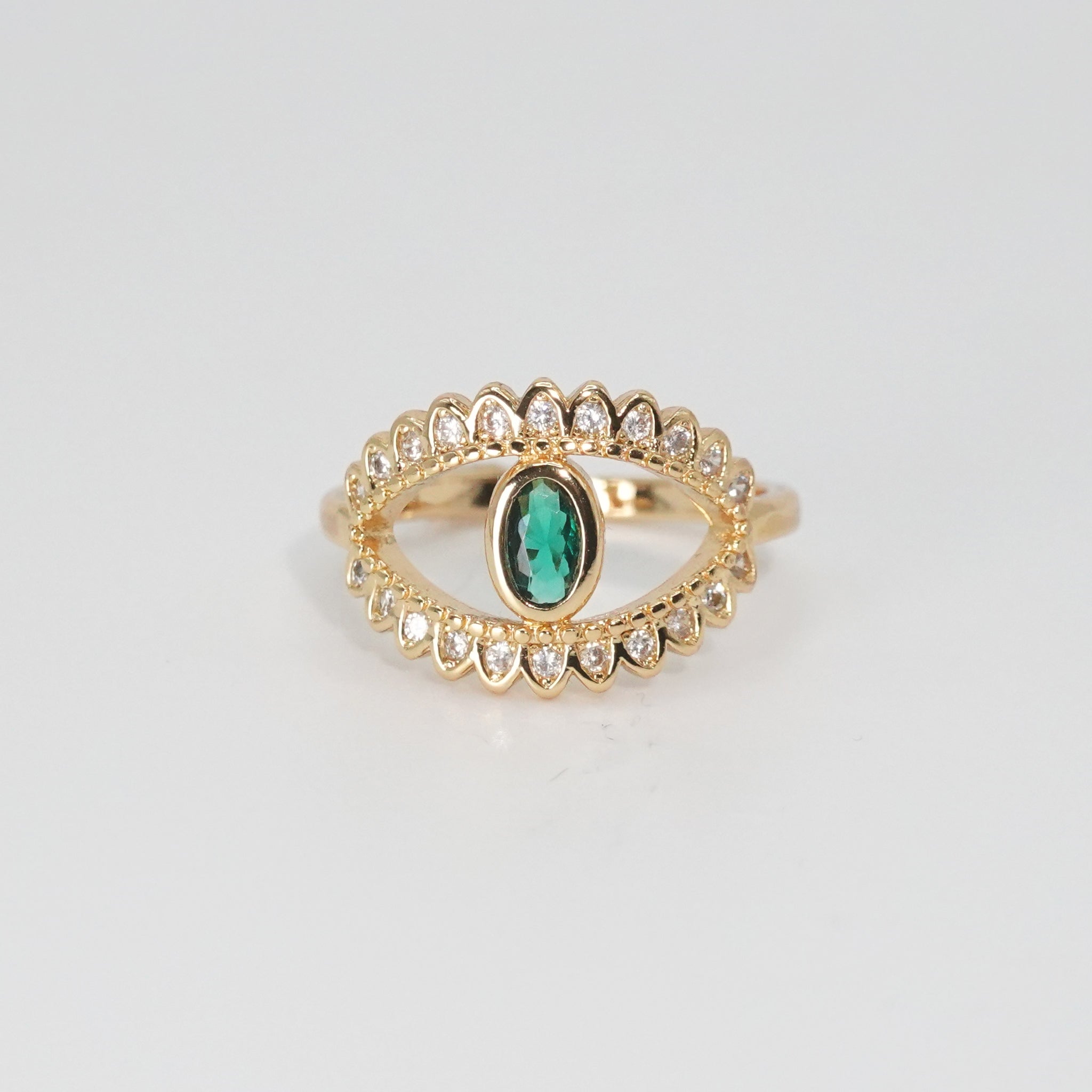 Glenneyre Ring: Eye-shaped design with shimmering stones and a striking green centerpiece, epitome of allure.