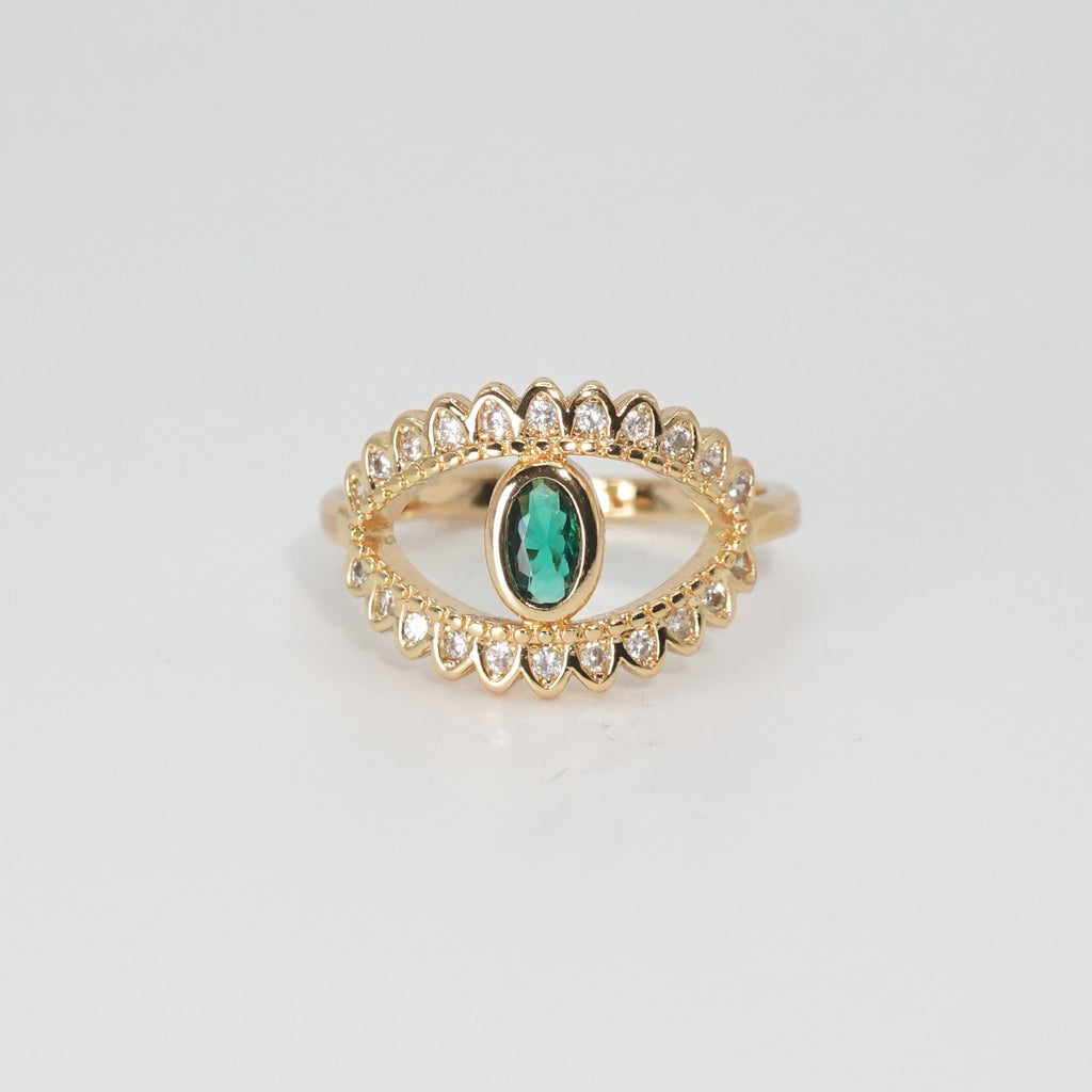 Glenneyre Ring: Eye-shaped design with shimmering stones and a striking green centerpiece, epitome of allure.