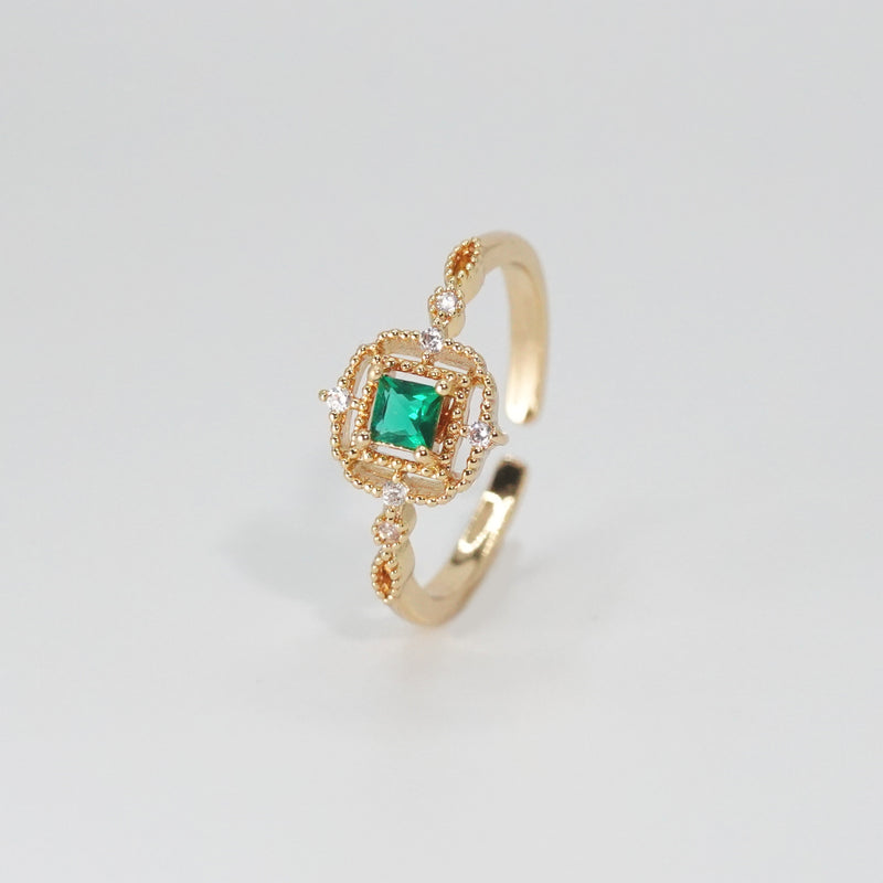 St. Ann's Ring: Shimmering stones encasing a striking square-shaped green centerpiece, epitome of sophistication.