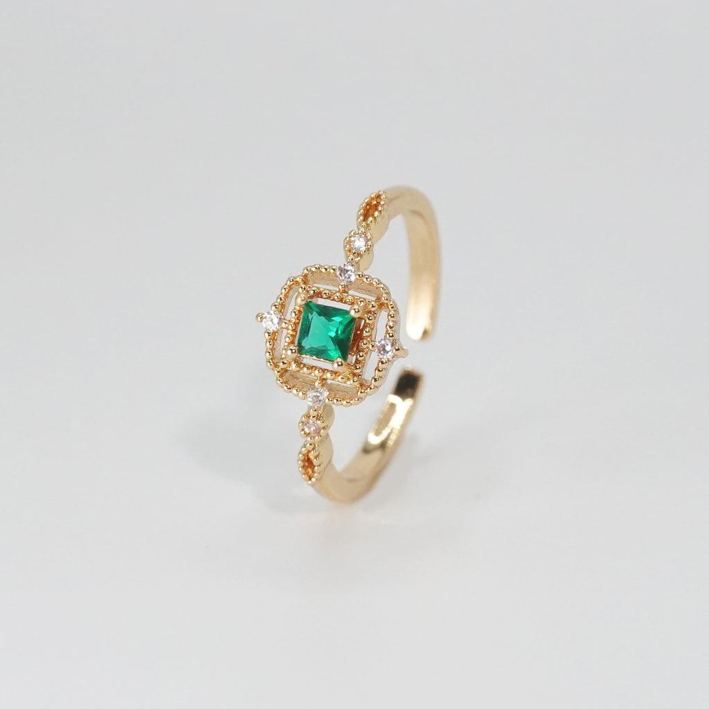 St. Ann's Ring: Shimmering stones encasing a striking square-shaped green centerpiece, epitome of sophistication.