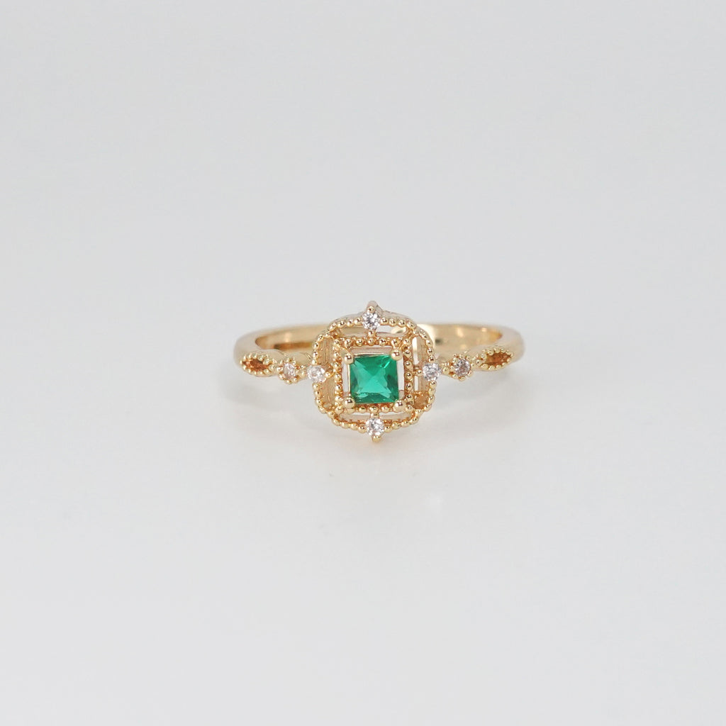 St. Ann's Ring: Shimmering stones encasing a striking square-shaped green centerpiece, epitome of sophistication.