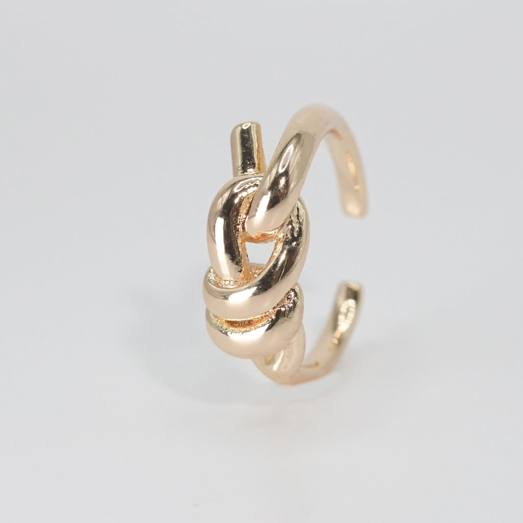 Lily Ring: Graceful knot design symbolizing timeless elegance, a sophisticated accessory.