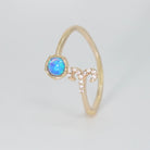 Aries Ring: Ram symbol with shimmering stones surrounding an opal, embodying fiery spirit.