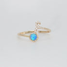 Aries Ring: Ram symbol with shimmering stones surrounding an opal, embodying fiery spirit.