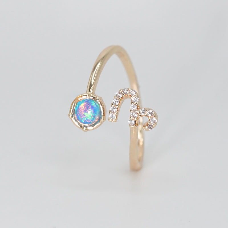 Capricorn Ring: Goat symbol with shimmering stones surrounding an opal, epitome of ambition.