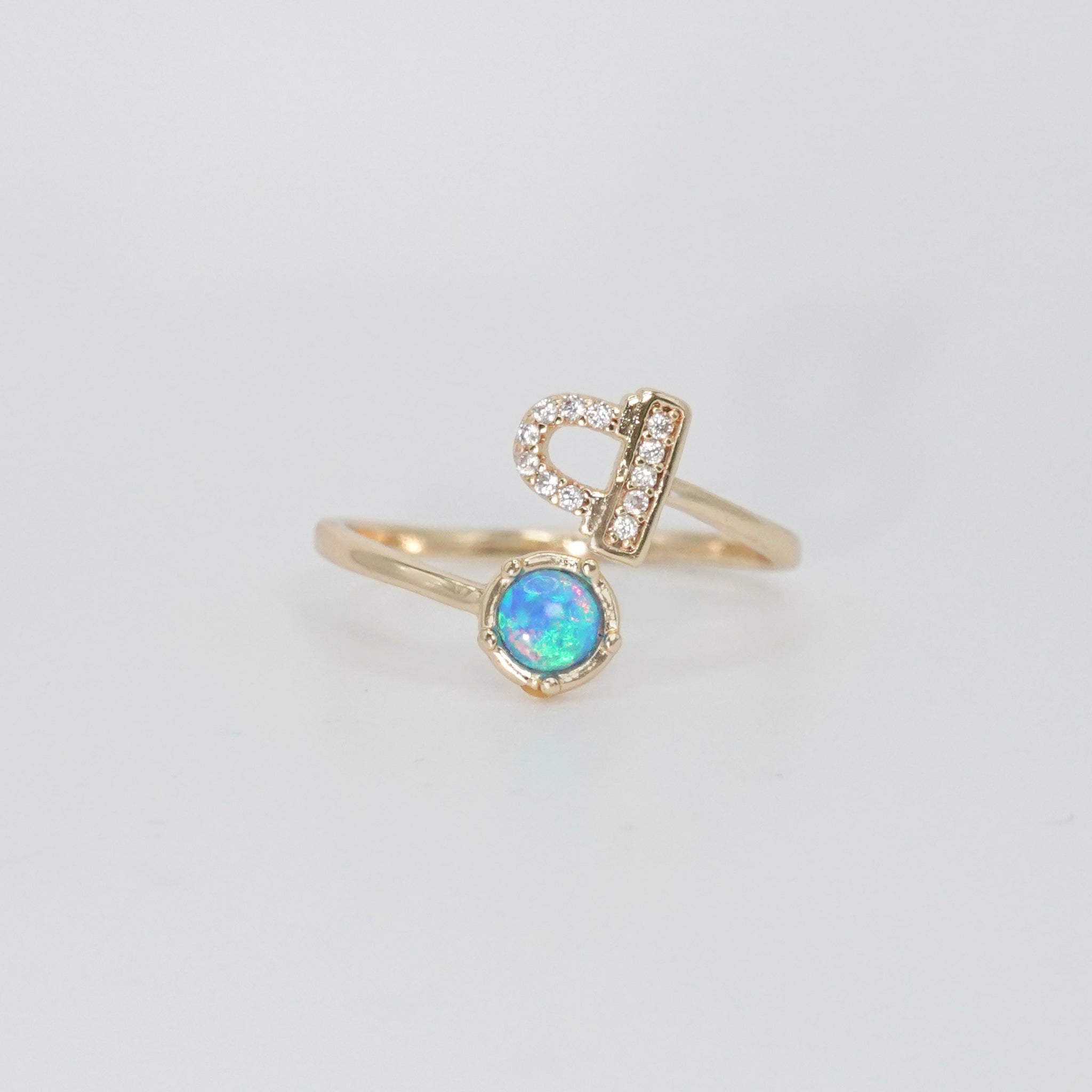  Libra Ring: Scales symbol with shimmering stones surrounding an opal, epitome of balance.