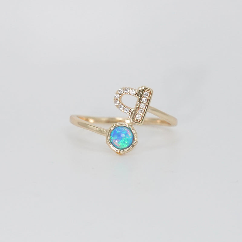  Libra Ring: Scales symbol with shimmering stones surrounding an opal, epitome of balance.