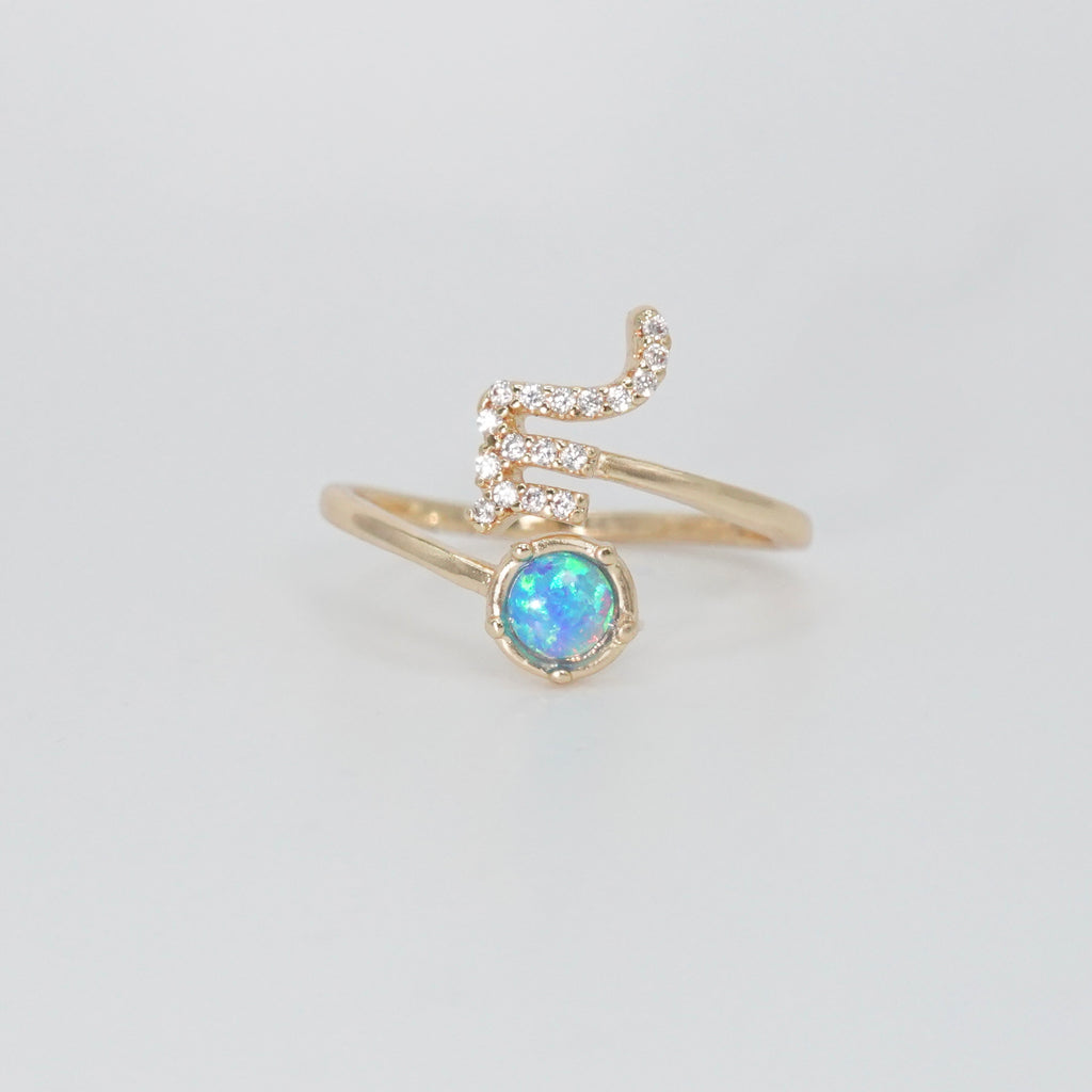 Scorpio Ring: Scorpion symbol with shimmering stones surrounding an opal, epitome of intensity.