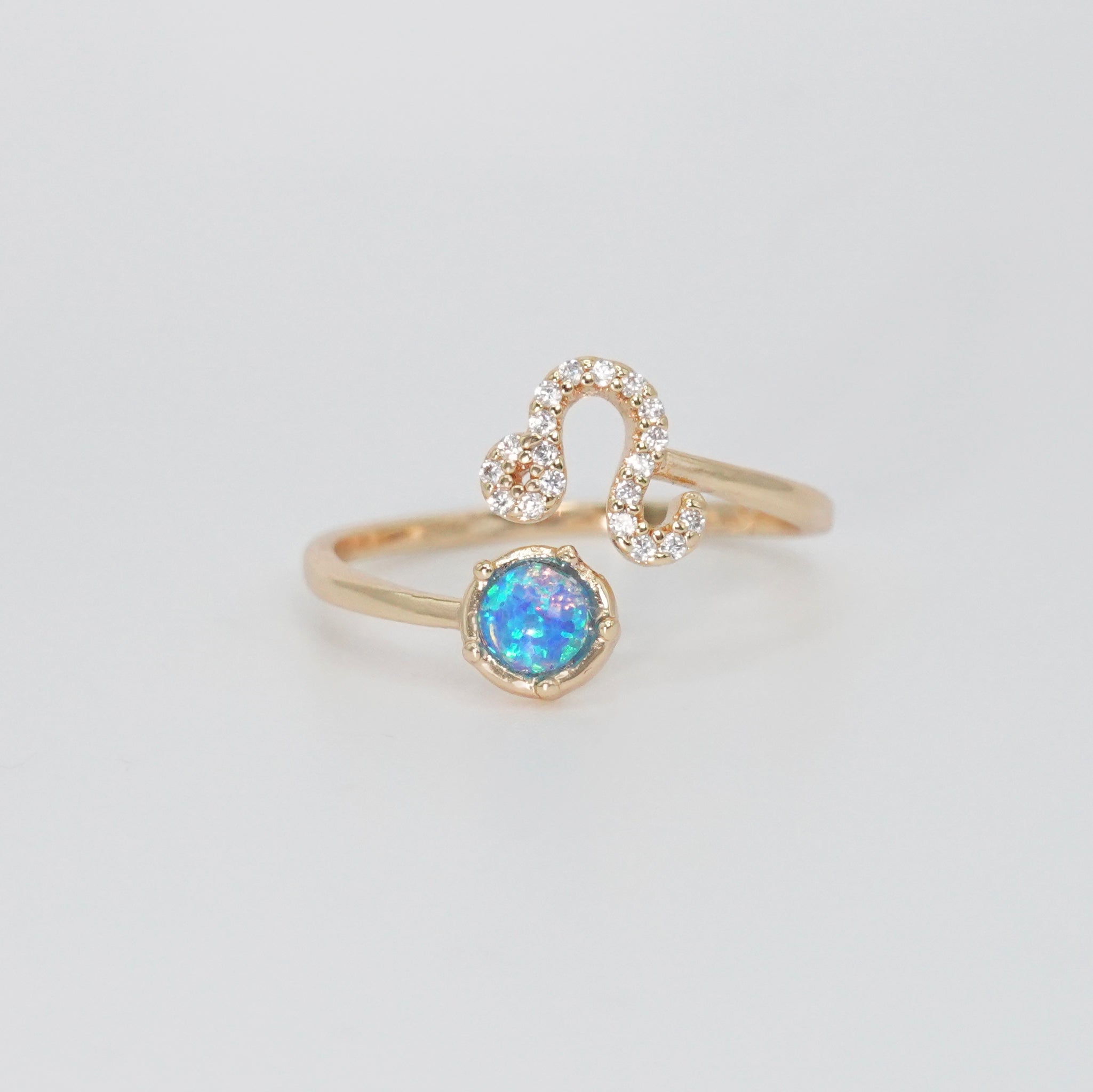 Leo Ring: Lion symbol with shimmering stones surrounding an opal, epitome of confidence.