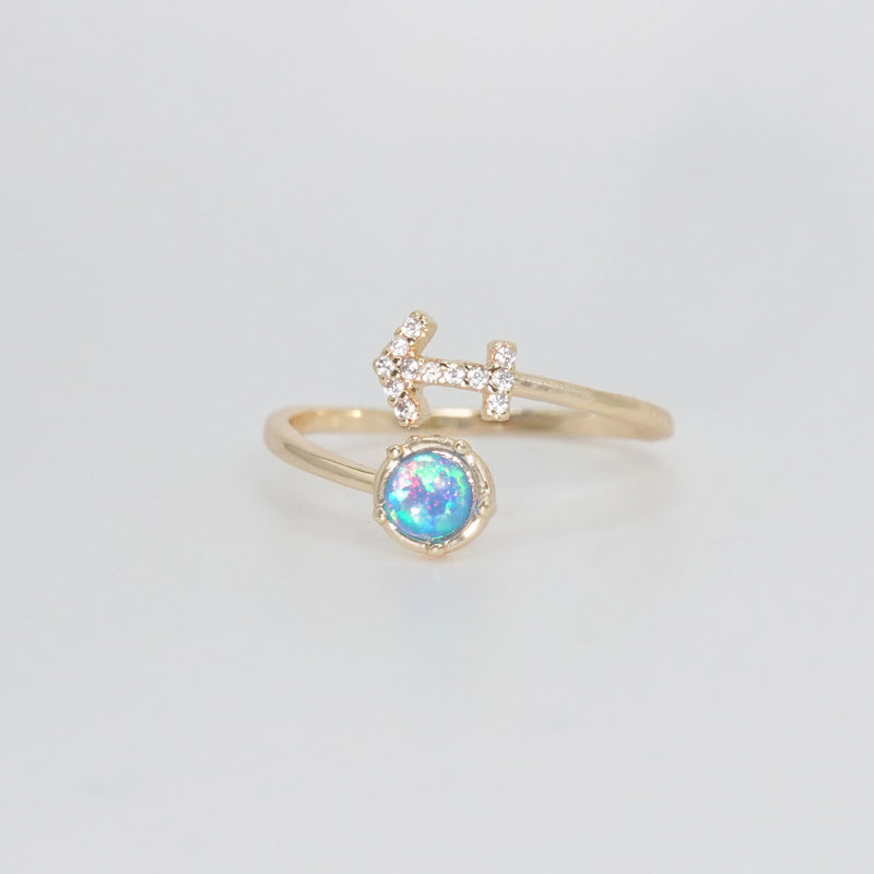 Sagittarius Ring: Archer symbol with shimmering stones surrounding an opal, epitome of adventure.
