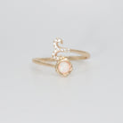 Aries Ring: Ram symbol with shimmering stones surrounding an opal, embodying fiery spirit.