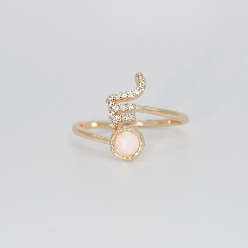 Scorpio Ring: Scorpion symbol with shimmering stones surrounding an opal, epitome of intensity.