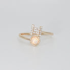 Gemini Ring: Twin symbols with shimmering stones surrounding an opal, symbolizing duality.