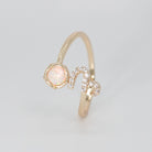 Capricorn Ring: Goat symbol with shimmering stones surrounding an opal, epitome of ambition.