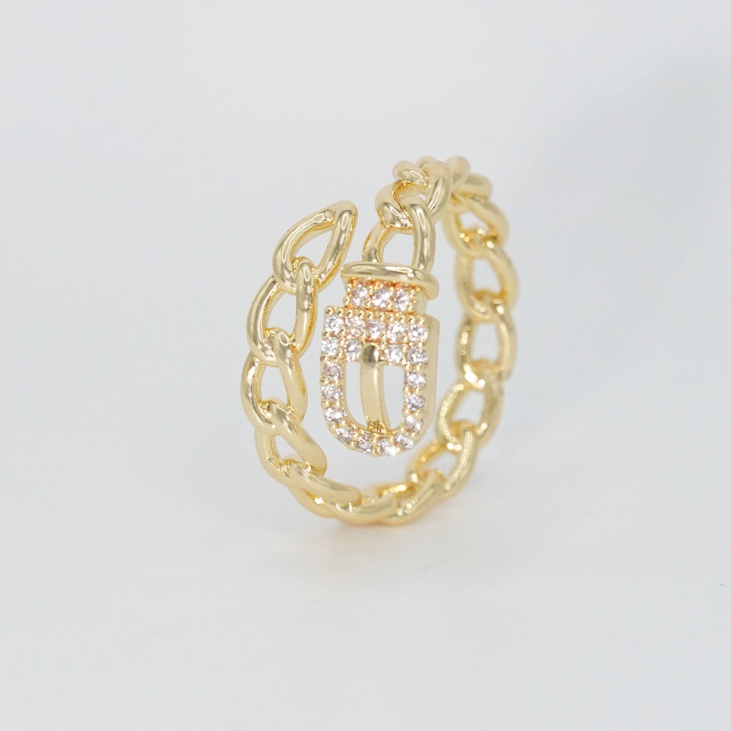  Radcliffe Ring: Chic chain and belt design adorned with dazzling stones, epitome of modern elegance.