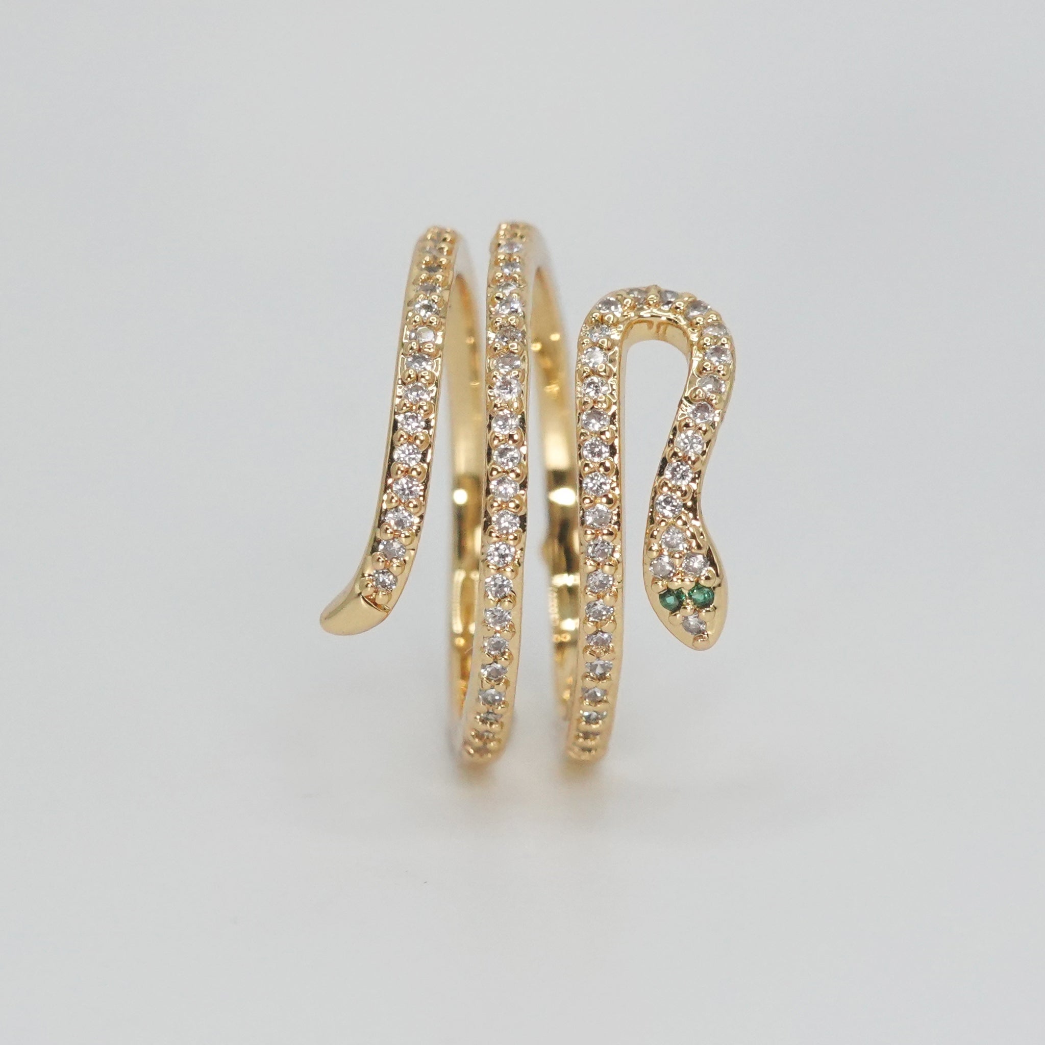 Rolling snake-shaped design with shimmering stones, epitome of elegance and mystique.