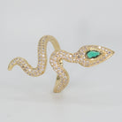 A dazzling array of shimmering stones with a captivating green gemstone at its head, epitome of sophistication.