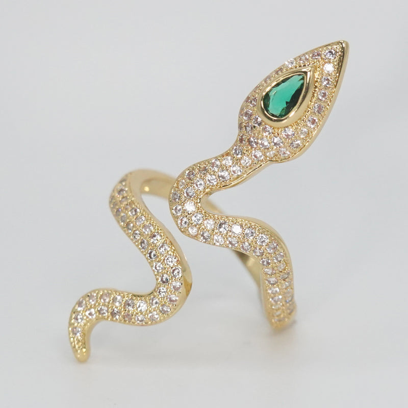 A dazzling array of shimmering stones with a captivating green gemstone at its head, epitome of sophistication.